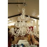 A modern twenty-four branch glass chandelier with swags and drop pendants,