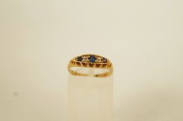 An 18ct gold diamond and sapphire five stone ring, with pieced gallery, Birmingham 1902,