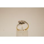 A three stone diamond ring, stamped '18ct Plat Set',