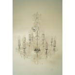 A modern twelve branch glass chandelier with swags and drop pendants,