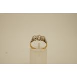 A three stone diamond 18ct gold ring,