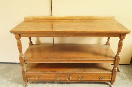 An early 20th century oak three tier buffet, the shelves above two single drawers, 96cm high,