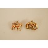A 9ct gold lion charm; with a 9ct gold elephant charm; 3.