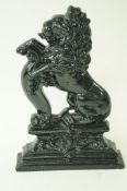 A cast iron lion doorstop, painted in black gloss,
