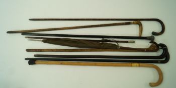 A Royal Artillery swagger stick, an ebony walking cane with a silver collar,