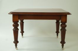 A Victorian mahogany dining table with two loose leaves and handle, on turned legs with casters,