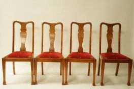 A set of four early 20th century walnut dining chairs with vase shaped splats,