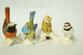 Four Goebel figures of birds, a blue tit, owl and two others, with a matt glaze,