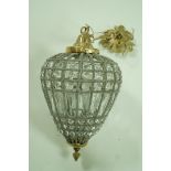 A hanging centre light with a cut glass and beaded frame,