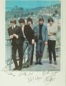 A signed Rolling Stones colour picture taken from the 1964 tour programme, signed by Brian Jones,