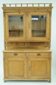 An early 20th century pine dresser, with a glazed open out top, with two shelves, 194cm high,