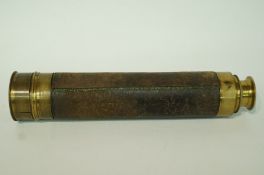 A late 19th century brass telescope with leather binding,