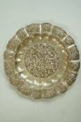 An Eastern pierced and moulded plate, the centre with buds and flowers,