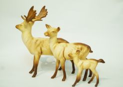 Three Beswick models of a stag, a doe and a fawn with matt glaze,