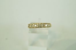 A seven stone diamond 9 carat gold half hoop ring,
