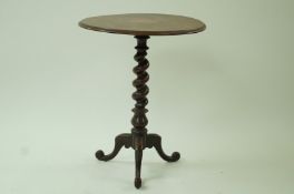 A Victorian mahogany occasional table, with a twist stem on a tripod base,