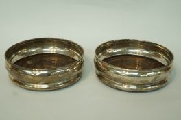 A pair of silver wine coasters, by DJ Silver Repairs, London 1966,