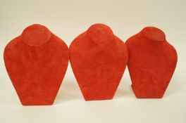 A set of three red suede necklace display stands,