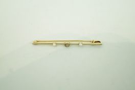 A diamond and pearl bar brooch, the central old cut diamond of approximately 0.