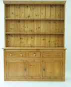 A large pine dresser and plate rack with three drawers and cupboards, 214cm high, 169cm long,