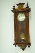 An early 20th century walnut cased Vienna regulator clock, with enamel dial,