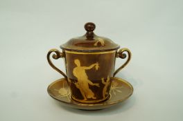 A late 19th century copper lustre cup, cover and saucer, painted in gilt,