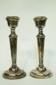 A pair of silver candlesticks, makers mark A.T.C.