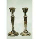 A pair of silver candlesticks, makers mark A.T.C.