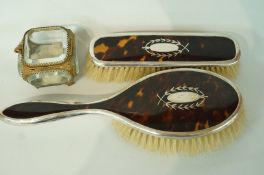A silver and tortoiseshell hair brush and matching clothes brush,