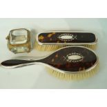 A silver and tortoiseshell hair brush and matching clothes brush,