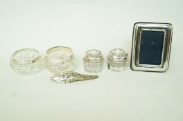 A pair of silver topped balm pots; a pair of glass salts with silver rims;