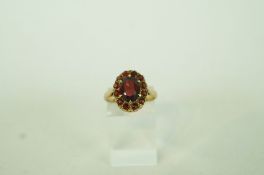 A garnet and yellow metal cluster ring, finger size O, 3.