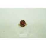 A garnet and yellow metal cluster ring, finger size O, 3.