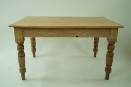 A pine kitchen table with turned legs and one drawer, 74cm high, 95cm wide,