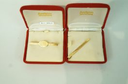 A bar tie pin, stamped '9ct', inscribed; and a tie slide, stamped '9ct, inscribed'; 6.