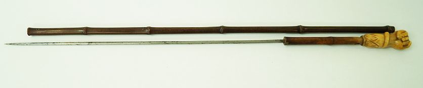 WITHDRAWN A 19th century sword stick with carved ivory fist clenching a serpent,