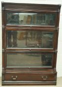 A mahogany three section Globe Wernick  bookcase, with column pilasters, above a single drawer,