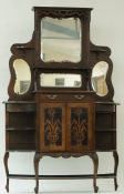 An early 20th century mahogany chiffonier, with a shaped mirrored back, on cabriole legs,