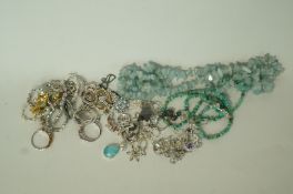 A collection of jewellery including silver mounted pendants