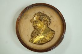 A gilt metal portrait bust of Charles Dickens and associated frame