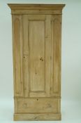 A pine single wardrobe, with a single drawer below, 200cm high, 94cm long,