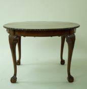 A Mahogany dining table with one loose leaf, and cabriole legs with ball and claw feet, 69cm high,