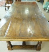 A large oak refectory table with five cleated plank top carved arcaded frieze on turned legs,