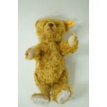 A modern Steiff jointed teddy bear button & label to the right ear,