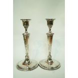 A pair of silver plated candlesticks,