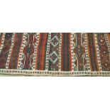 A Kilim rug, woven with multiple geometric bands,