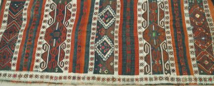 A Kilim rug, woven with multiple geometric bands,