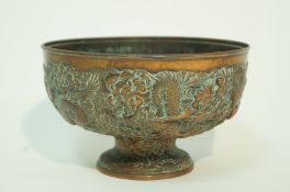 A late 19th century Chinese copper bowl, moulded with dragons and over lapping flower heads, 14.