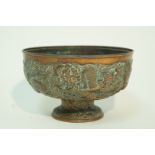 A late 19th century Chinese copper bowl, moulded with dragons and over lapping flower heads, 14.