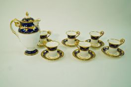 A Minton porcelain coffee service in Empire style, decorated with raised gilding on a blue ground,